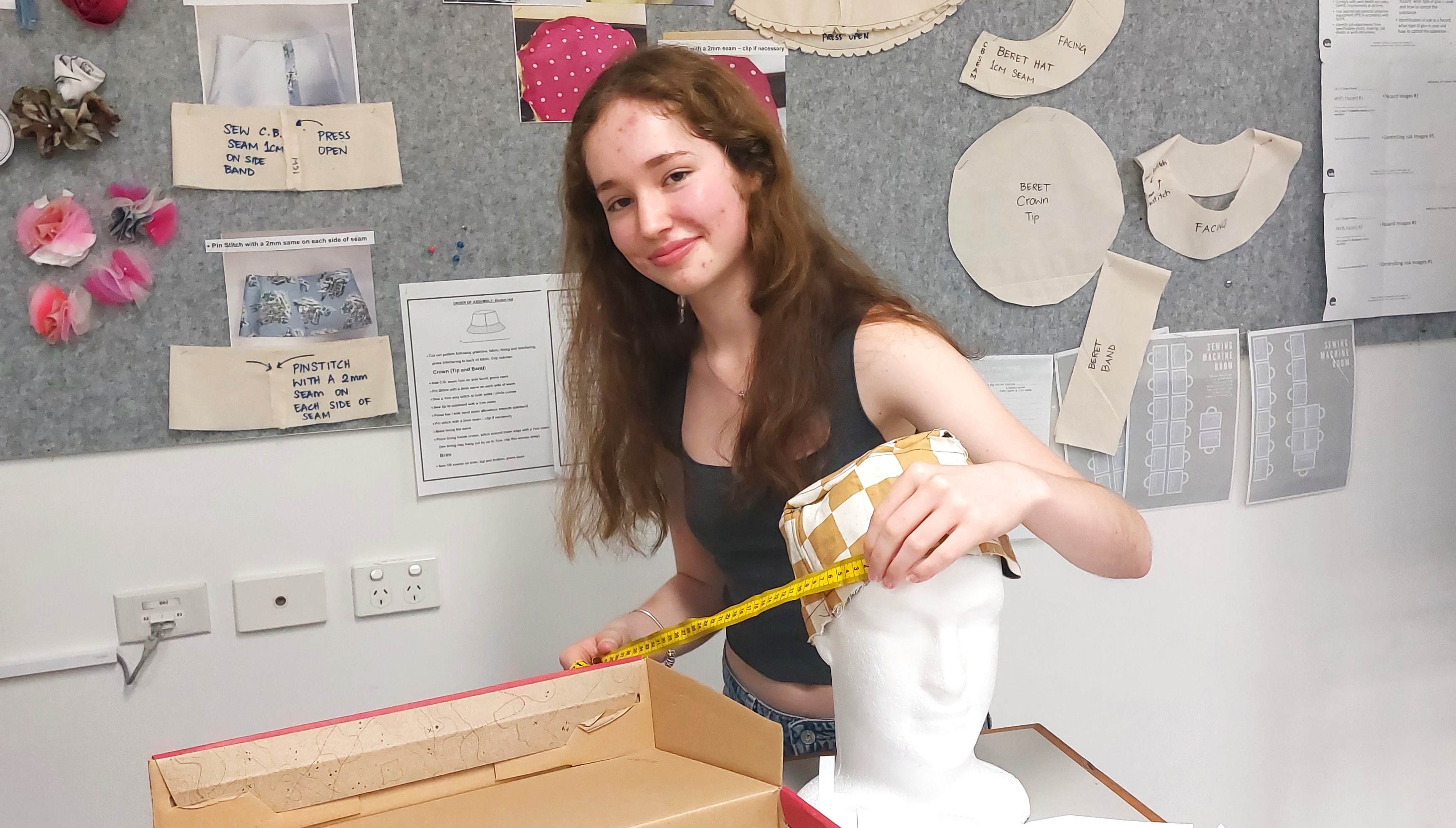 student measuring and creating a textile project, reflecting design thinking, creativity and practical skills development