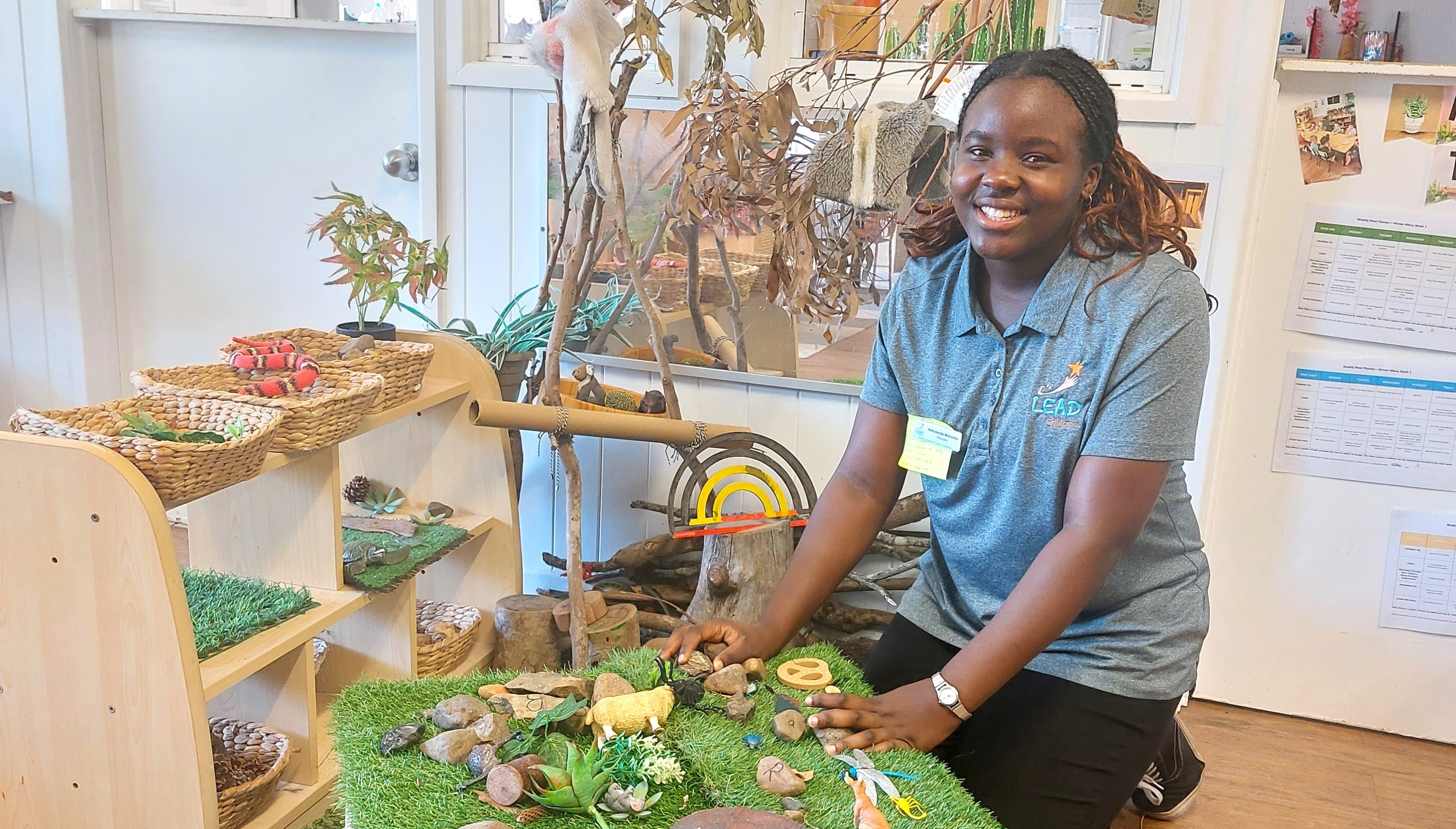 student engaging in hands-on early learning activity with natural materials, representing play-based learning and exploration