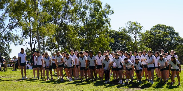 Students gathered at the start of a running event on the school oval, highlighting participation teamwork and school spirit at San Sisto College