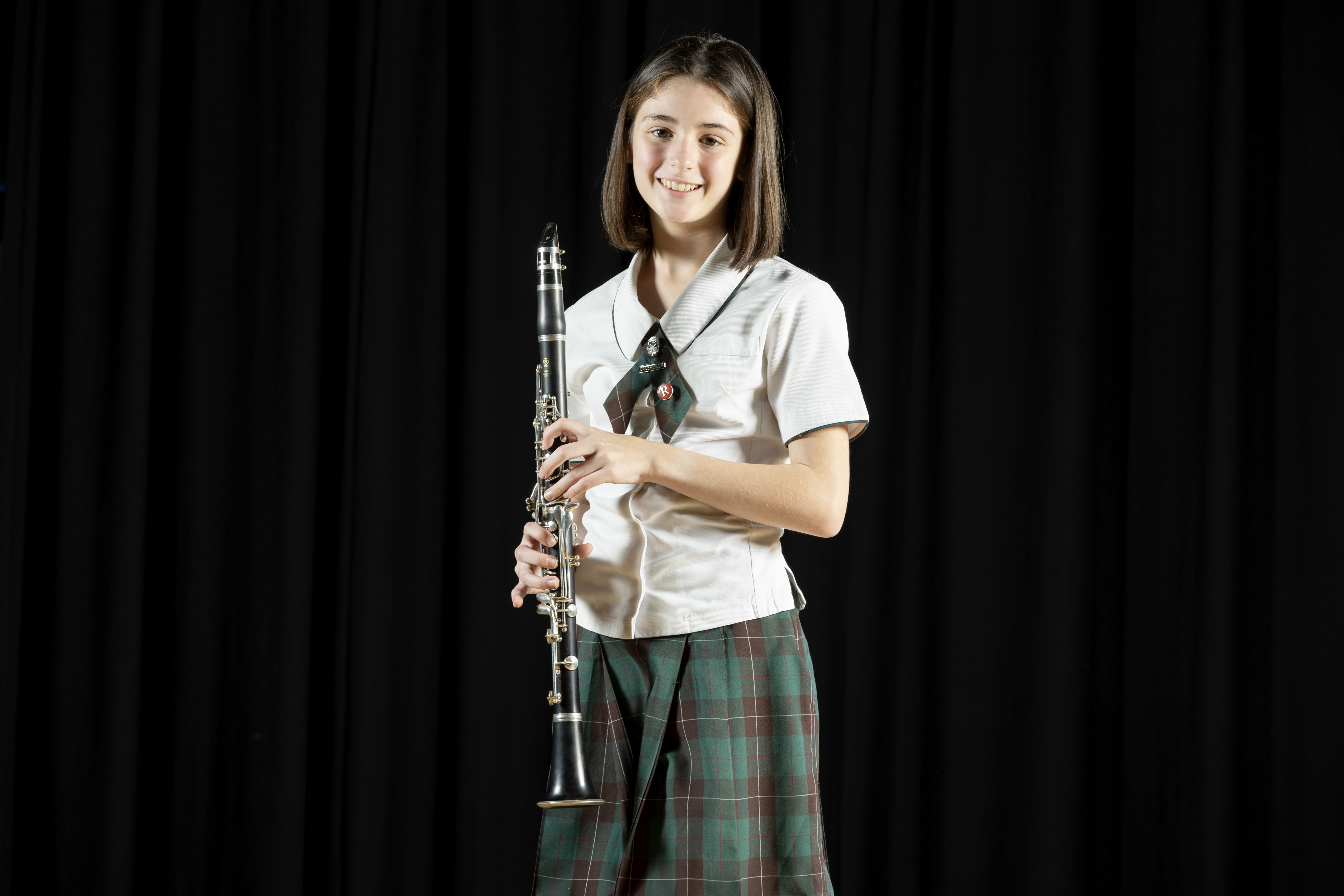 student performing with a musical instrument, reflecting participation in music and co-curricular performing arts