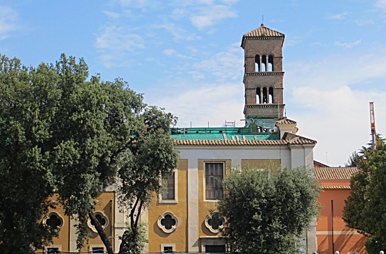 Historic church building with bell tower and surrounding gardens, representing Catholic heritage and the origins of the San Sisto College community