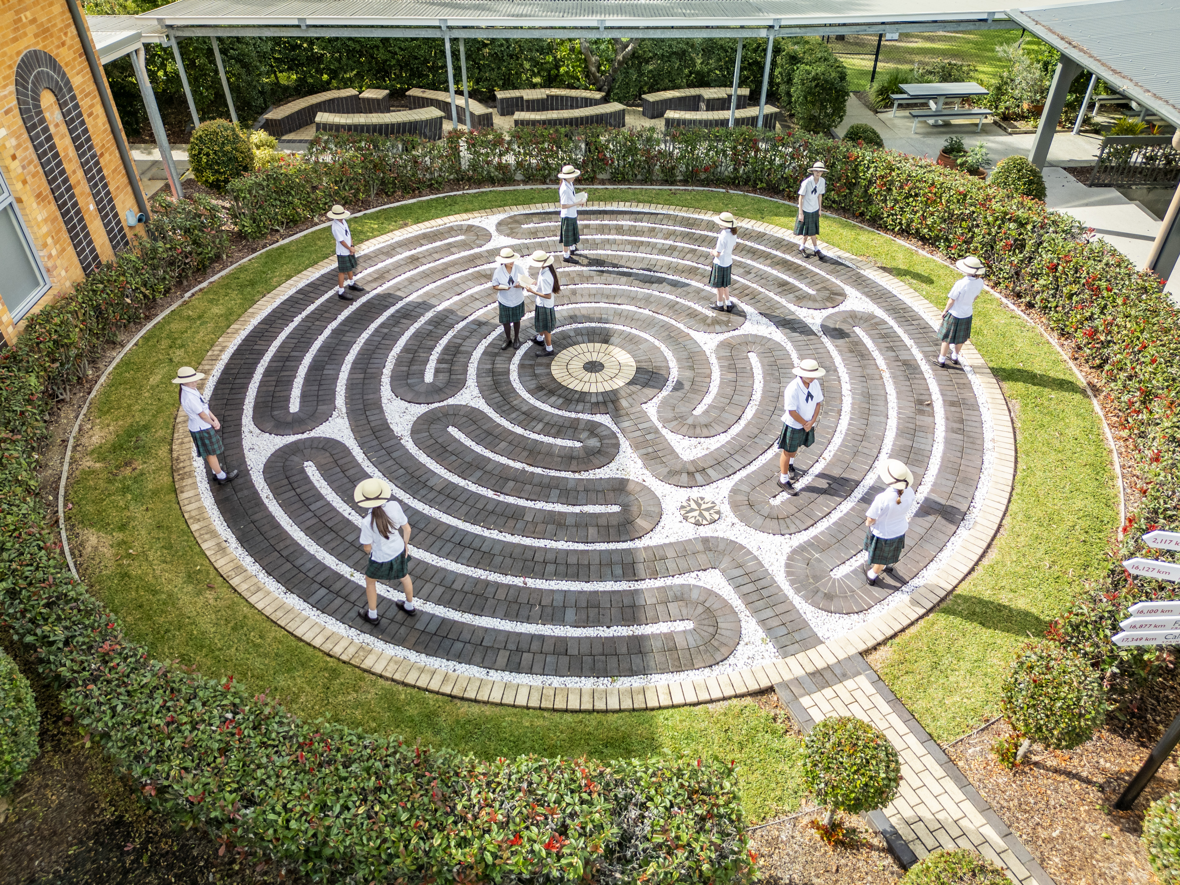 Students standing within a labyrinth on school grounds, highlighting reflection mindfulness and community connection at San Sisto College