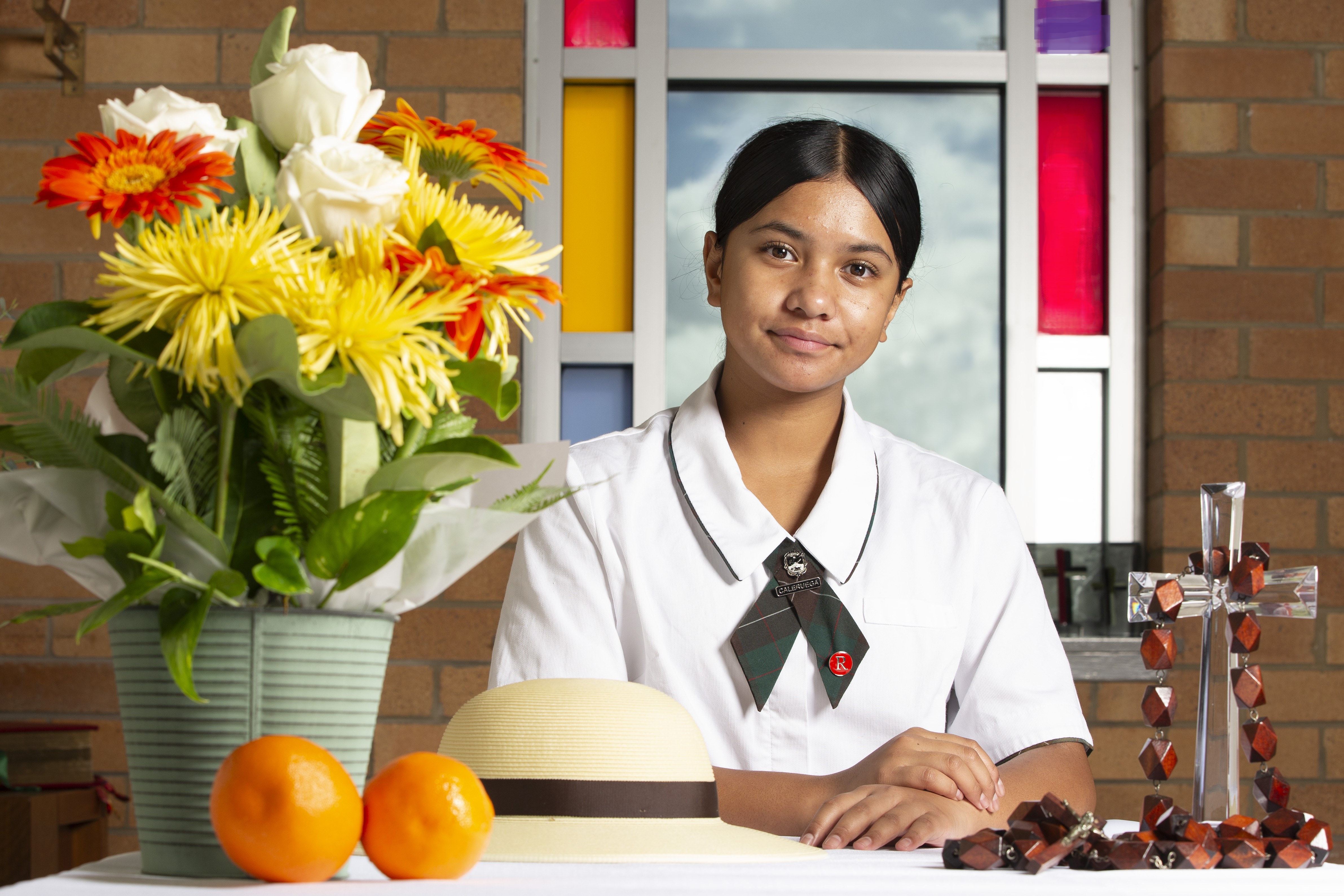 student engaging in prayerful reflection within a school setting, representing faith formation and the religious life of the school