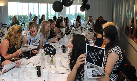 staff seated together at a formal luncheon event, reflecting professional development, community building and collaboration