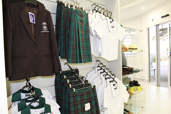 School uniform display at San Sisto College shop featuring jackets skirts shirts and accessories, supporting student identity and uniform requirements